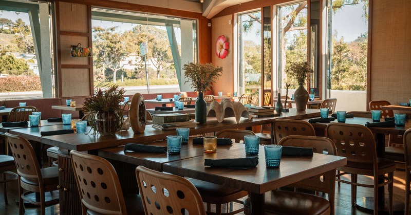 Spacious and cozy interior dining area with set tables ready for guests