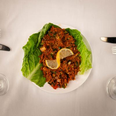 Tabbouleh spread over lettuce leaves.