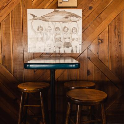 Interior, a table with bar stools, a vintage photo on the wall