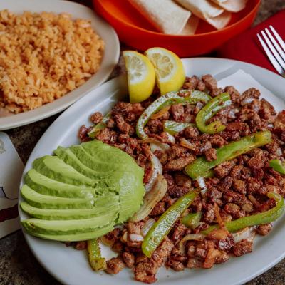 Tacos Chihuahua served deconstructed with sides of rice and beans.