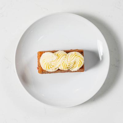 Carrot cake topped with cream cheese frosting.