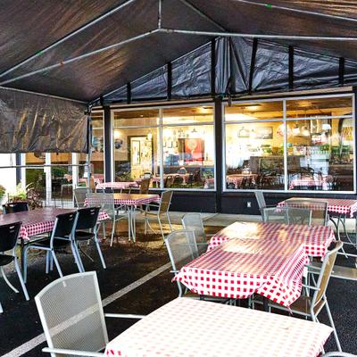 Exterior, tent diner area, tables, chairs.