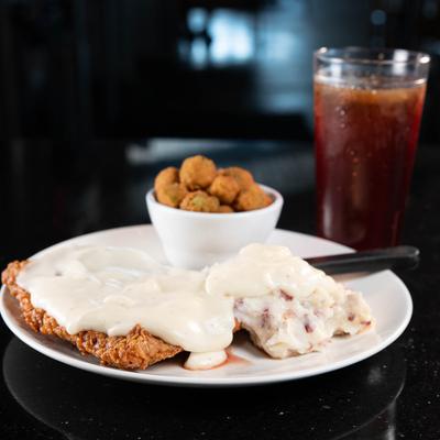 Chicken fried steak plate and soda drink.