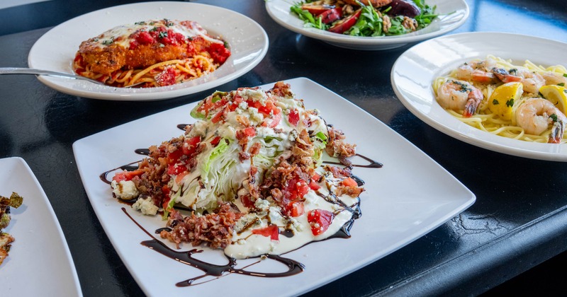 Wedge salad served on the table with other dishes in the background