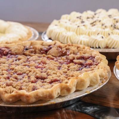Mixed Berry Pie displayed with assorted pies.