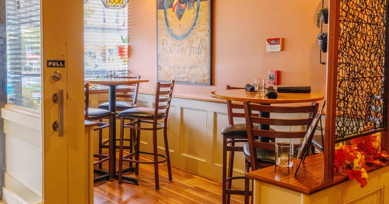 Two tables with bar stools in a separate part of the bistro