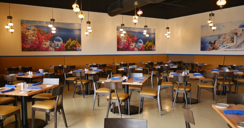 Interior of spacious dining area with dining tables set for guests