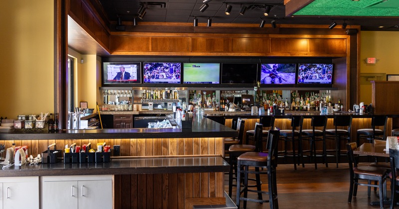 Bar, drink rack, tv screens above