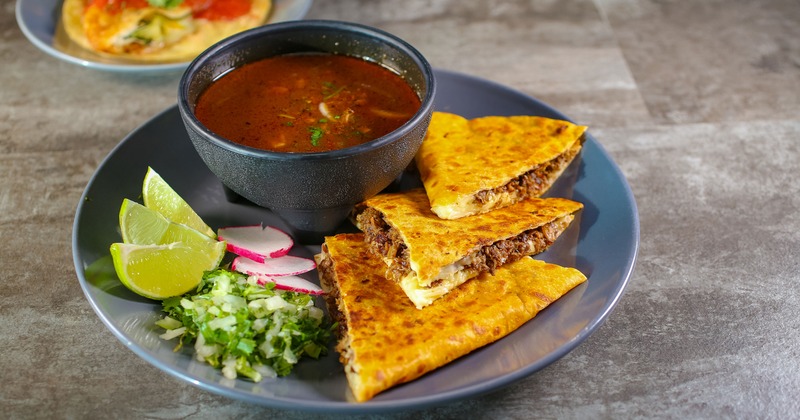 Steak quesadillas served with beef broth