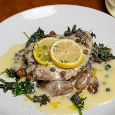 Chicken Picatta, served with fingerling potatoes, sauteed kale, and lemon caper wine sauce.