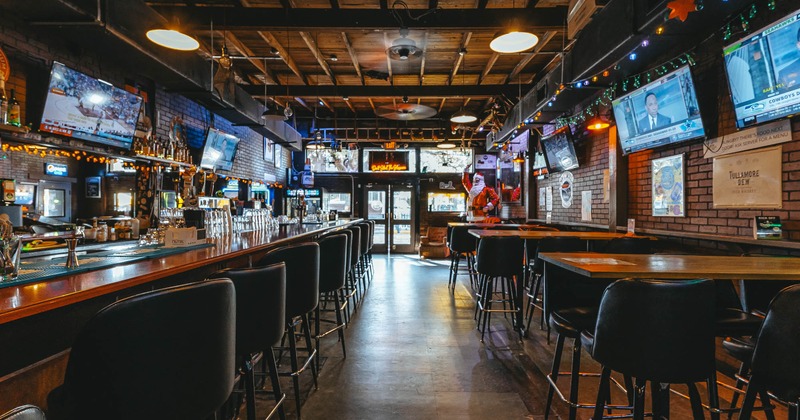 Bar area on the left and tall tables with bar stools on the right