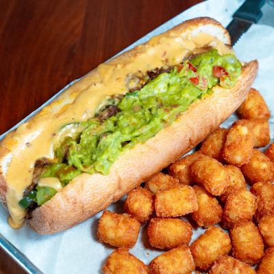 The San Diego cheese steak sandwich, served with tots.