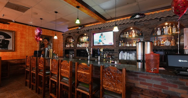 Interior, bar area, marble top bar with wooden hand-carved bar stools