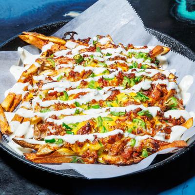 Loaded fries topped with bacon bits, cheese, green onions and ranch dressing.