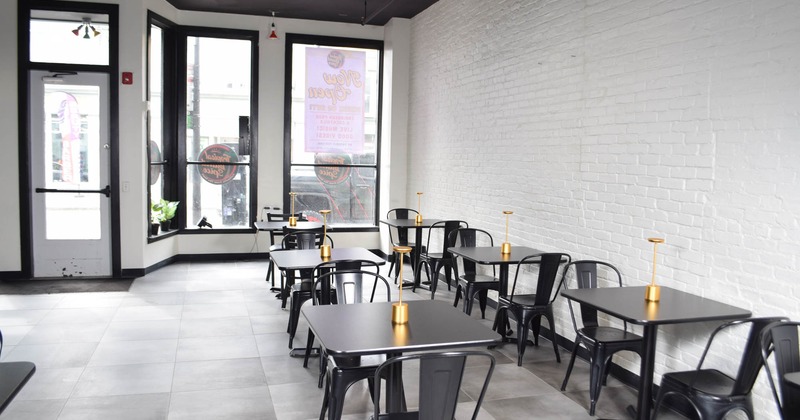 Interior, dining area, tables for two, restaurant entrance, shop window, tile flooring