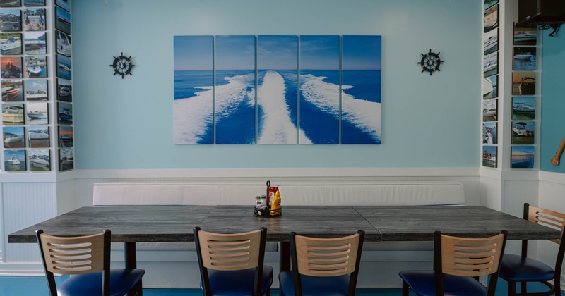 Interior, table and chairs near wall with picture