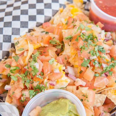 Nacho basket with salsa, guacamole and sour cream