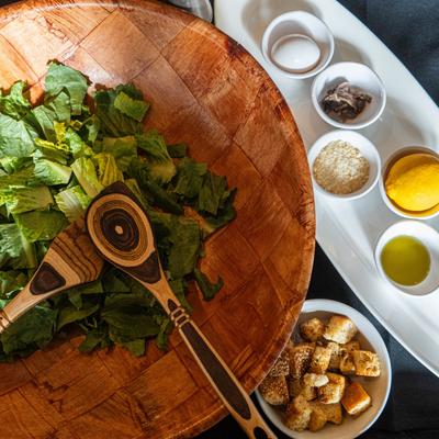 Traditional Caesar salad, assorted ingredients served in multiple dishes