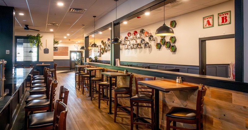 Interior, bar area with tall tables and bar stools