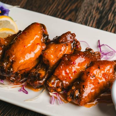Sweet Chili Wings served on a bed on shredded red cabbage.