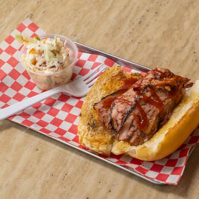 Brisket sandwich served with coleslaw on the side.