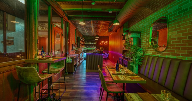 Interior, bar and lounge area, high table for two, banquette bench with tables and chairs