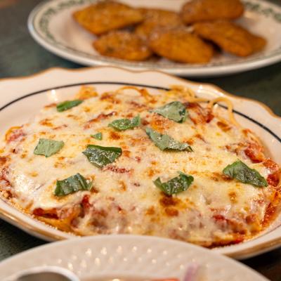 Spaghetti with tomato sauce and melted cheese.