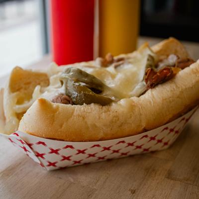 Chicago Italian Beef sandwich with melted cheese and pickles.