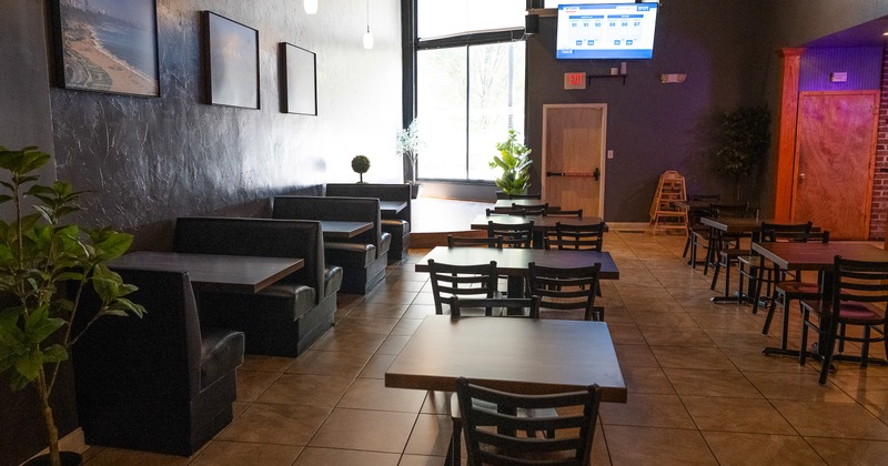 Spacious interior dining area with tables, chairs and dining booths