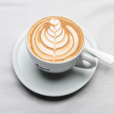 Cup of cappuccino, coffee art pattern on the surface