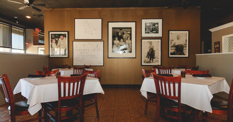 Interior, dining tables, walls decorated with framed old photos