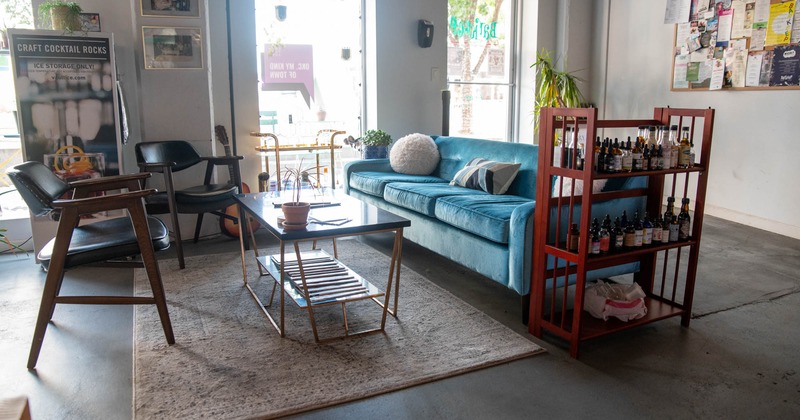 Interior, large blue sofa, coffee table and chairs, shop window, restaurant entrance