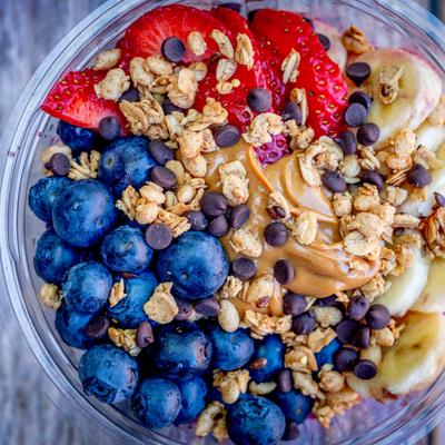 acai bowl with blueberries, strawberries, banana, peanut butter, gf mini chocolate chips and gf granola.