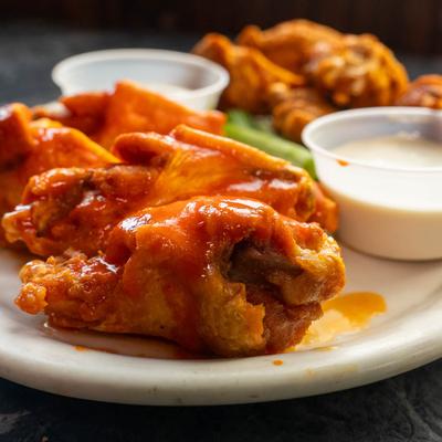 Chicken wings served with celery, ranch and bleu cheese sauces.