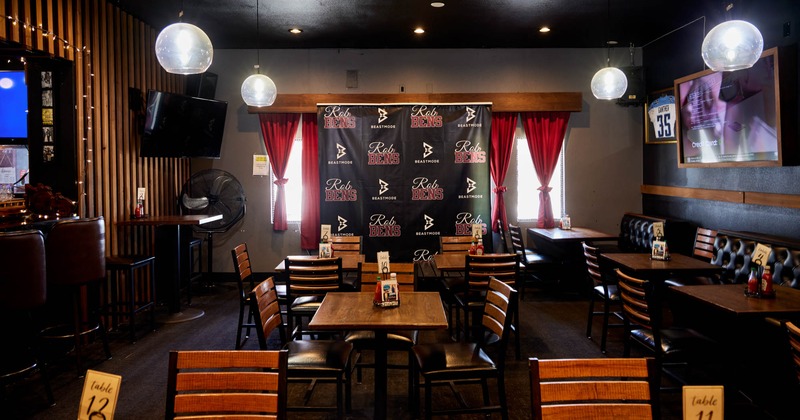 Interior, tables ready for guests, TV on the wall