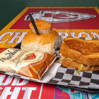Grilled sandwich, stuffed bun and a bag of potato chips.