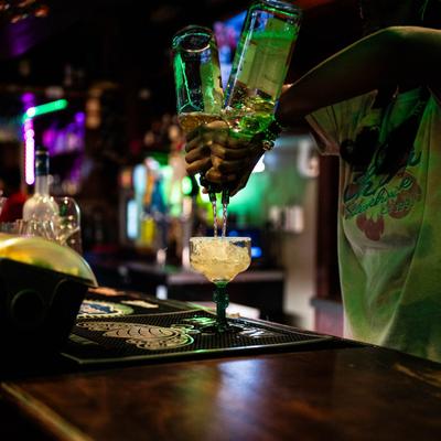 A bartender prepares a mixed drink.