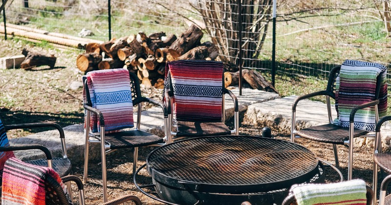 Exterior, chairs with blankets, gathered around grill campfire