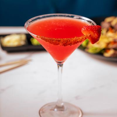 Pink Panther in a chili-rimmed martini glass, garnished with a slice of strawberry.
