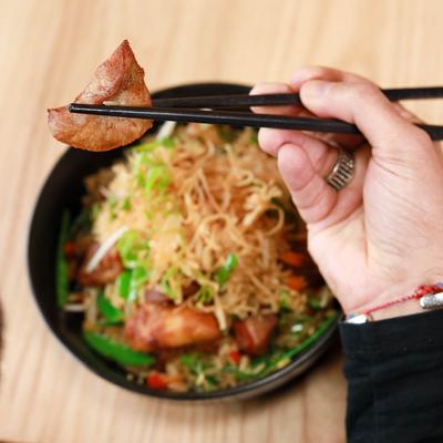 Eating Peruvian Fried Rice dish with chopsticks, top view