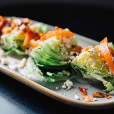 Wedge Salad, with ranch dressing, tomato, blue cheese, and bacon.