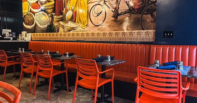Interior, tables, orange chairs and orange leather seating