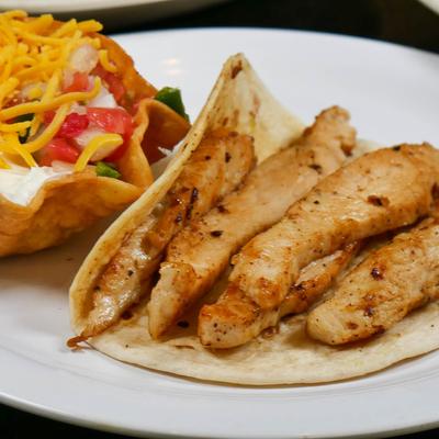 Grilled chicken taco with a taco salad.