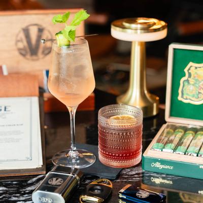 Luxurious tabletop with drinks, cigars in a box and cigar accessories