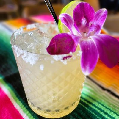 Yellow drink with salt, orchid and lime.