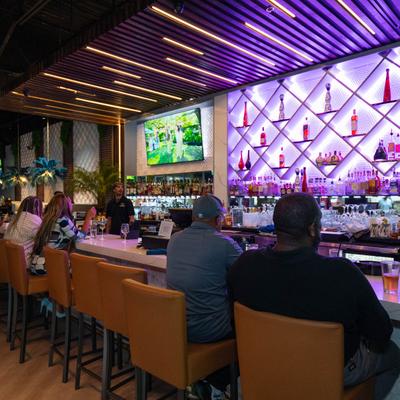 Customers sitting at the bar.