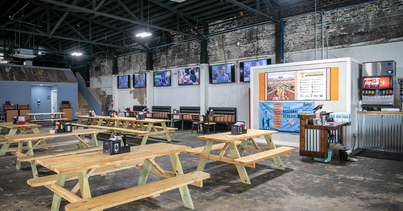 Interior, tables and benches, TVs on the wall