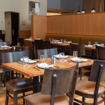Tables set up in lower dining area for diners