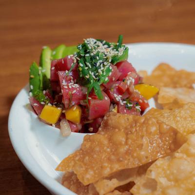 Ahi Poke Bowl, with pico de gallo, avocado, mango, ponzu sauce, sesame, and wonton chips.