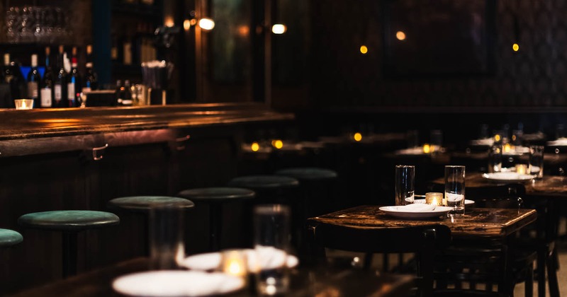Interior, tables and chairs near bar